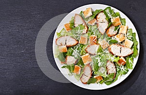 Plate of chicken caesar salad, top view photo