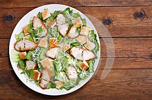 Plate of chicken caesar salad, top view