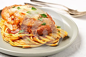 Plate of chicken parmigiana with spaghetti