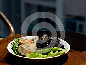 A plate of chicken rice with brown rice