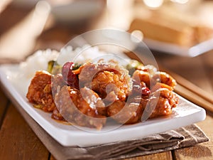 Plate of chinese general tsos chicken with rice and broccoli