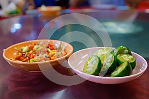 Plate of Chopped Chilli and Plate of Cut Limes