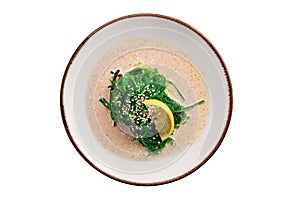 Plate with chuka salad, nut sauce and sesame isolated on white