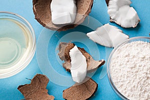 Plate with coconut flour and water on blue background photo