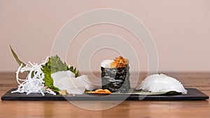 Plate composed of squid and cuttlefish sashimi, caviar and fermented soy gunkan, grilled squid nigiri