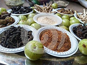 A plate containing ayurvedic medicinal dry herbs, collected for making medicinal formulation. Martynia annua, terminalia chebula,