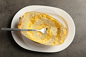 Plate with cooked spaghetti squash and fork