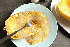 Plate with cooked spaghetti squash and fork