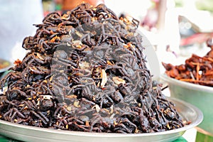 Plate of cooked spider sold in a Cambogian street market