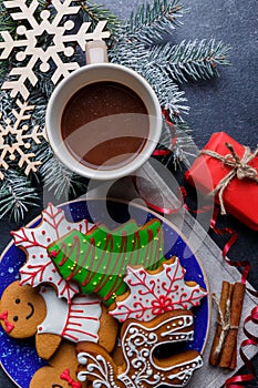 A plate with cookies next to a cup of hot chocolate. Top view of a closeup