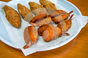 A plate of crispy and delicious fried butterfly prawns and fried cod sticks