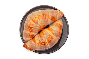 Plate with croissants on a white background. View from above. French pastries