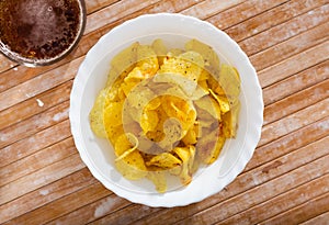 Potato chips served with glass of beer