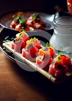 plate of cubed sushi with vegetable decoration