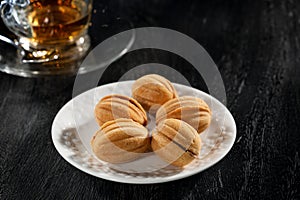 Plate and cup of tea on white background