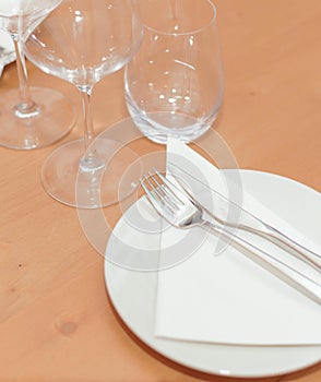 plate, cutlery and glasses set for an elegant dinner photo