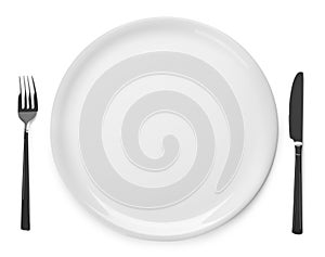 Plate and cutlery on white background, top view