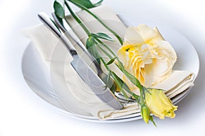 Plate, cutlery and yellow flower