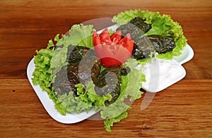 Plate of Armenian Grape Leaves Rolls Called Dolma Tolma with Yogurt Dip photo