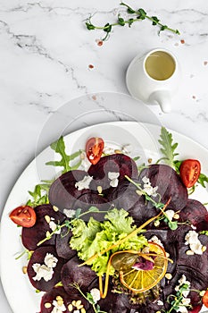 Plate with delicious beetroot carpaccio with feta, vertical image. top view. place for text