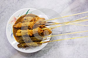 A plate of delicious chicken and lamb satay with peanut sauce.