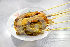 A plate of delicious chicken and lamb satay with peanut sauce.