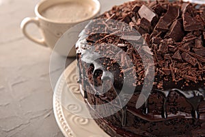 Plate with delicious chocolate cake on light table, closeup