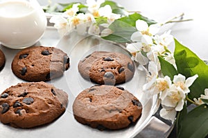 Plate with delicious chocolate chip cookies on table, closeup