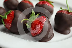 Plate with delicious chocolate covered strawberries photo