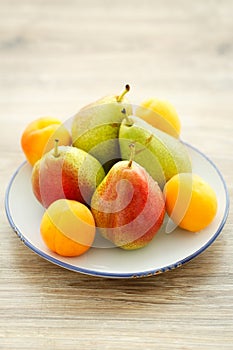 Plate of delicious fresh pears and apricots