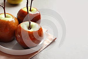 Plate with delicious green caramel apples