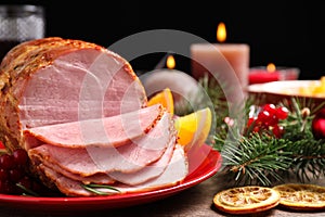 Plate with delicious ham served on wooden table. Christmas dinner