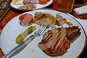 Plate with delicious hot food at the brasserie