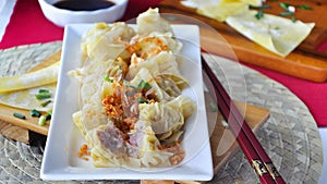 Plate of Delicious Pork Wanton with Chopsticks on Wooden Board