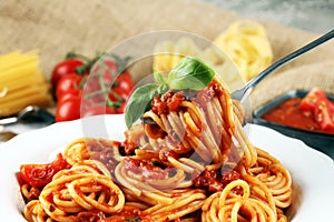 Plate of delicious spaghetti Bolognaise or Bolognese with savory minced beef and tomato sauce garnished with parmesan