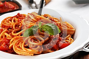 Plate of delicious spaghetti Bolognaise or Bolognese with savory minced beef and tomato sauce garnished with parmesan