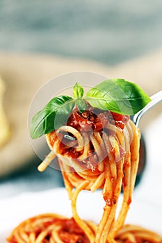 Plate of delicious spaghetti Bolognaise or Bolognese with savory minced beef and tomato sauce garnished with parmesan