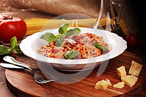 Plate of delicious spaghetti Bolognaise or Bolognese with savory minced beef and tomato sauce garnished with parmesan