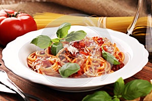 Plate of delicious spaghetti Bolognaise or Bolognese with savory minced beef and tomato sauce garnished with parmesan