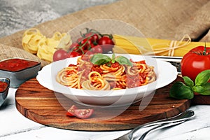 Plate of delicious spaghetti Bolognaise or Bolognese with savory minced beef and tomato sauce garnished with parmesan