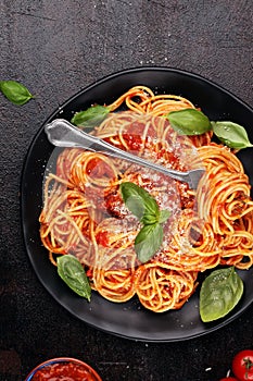 Plate of delicious spaghetti Bolognaise or Bolognese with savory minced beef and tomato sauce garnished with parmesan