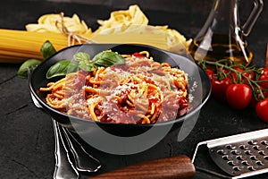 Plate of delicious spaghetti Bolognaise or Bolognese with savory minced beef and tomato sauce garnished with parmesan