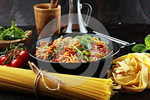 Plate of delicious spaghetti Bolognaise or Bolognese with savory minced beef and tomato sauce garnished with parmesan