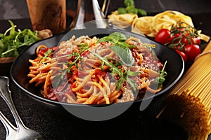 Plate of delicious spaghetti Bolognaise or Bolognese with savory minced beef and tomato sauce garnished with parmesan