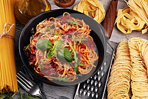 Plate of delicious spaghetti Bolognaise or Bolognese with savory minced beef and tomato sauce garnished with parmesan