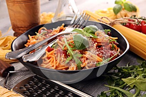 Plate of delicious spaghetti Bolognaise or Bolognese with savory minced beef and tomato sauce garnished with parmesan