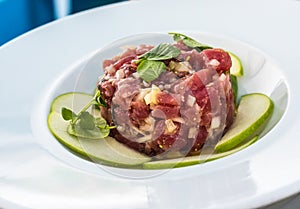 A plate of delicious tuna tartare with green apple