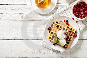 Plate with delicious waffles with berries and ice cream. Top view, place for text