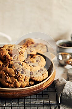 Plate with deliciously baked cookies with chocolate chips on a baking grid