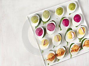 A plate of deviled eggs on white background.